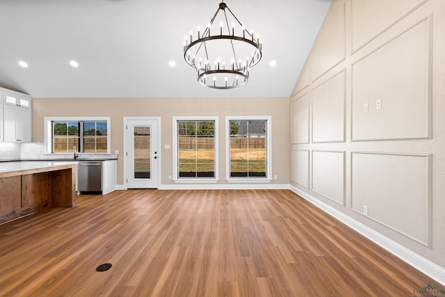 169 Andres Ln, Kilgore, TX 75662 - kitchen with a decorative wall, light wood-style flooring, a chandelier, dishwasher, and vaulted ceiling