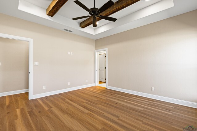 169 Andres Ln, Kilgore, TX 75662 - empty room with beam ceiling, light wood-style flooring, baseboards, visible vents, and ceiling fan
