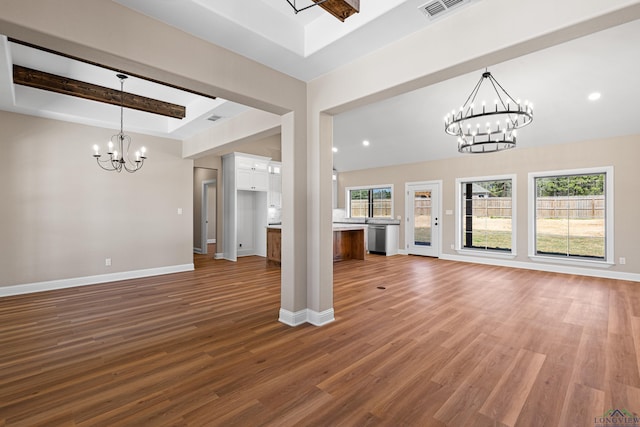 169 Andres Ln, Kilgore, TX 75662 - unfurnished living room featuring visible vents, a wealth of natural light, wood finished floors, and an inviting chandelier