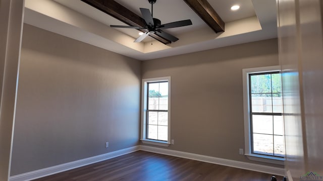 spare room with plenty of natural light, baseboards, ceiling fan, and dark wood-type flooring