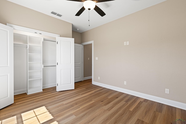 169 Andres Ln, Kilgore, TX 75662 - unfurnished bedroom with a closet, light wood-type flooring, baseboards, visible vents, and ceiling fan