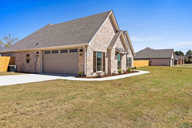 169 Andres Ln, Kilgore, TX 75662 - view of front of home with cooling unit, fence, an attached garage, driveway, and brick siding