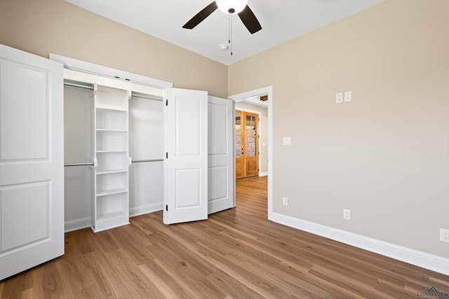 169 Andres Ln, Kilgore, TX 75662 - unfurnished bedroom featuring baseboards, a closet, wood finished floors, and ceiling fan
