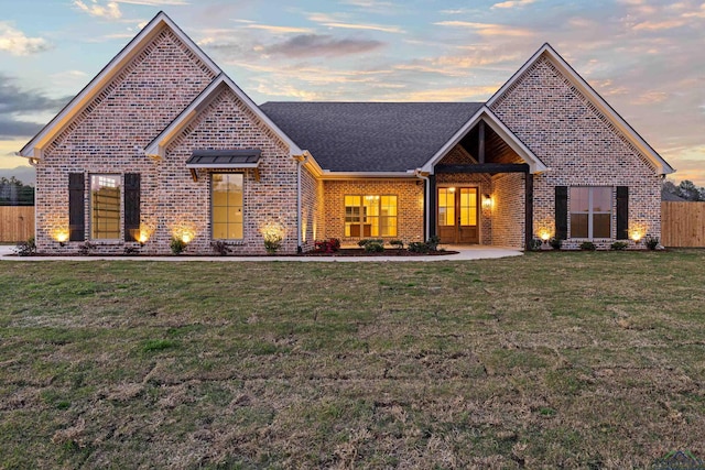 169 Andres Ln, Kilgore, TX 75662 - view of front of house featuring brick siding, fence, a front lawn, and a shingled roof