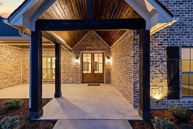 169 Andres Ln, Kilgore, TX 75662 - view of exterior entry featuring brick siding, french doors, and a patio area