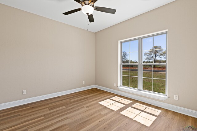 169 Andres Ln, Kilgore, TX 75662 - unfurnished room featuring a ceiling fan, baseboards, and wood finished floors