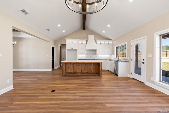 169 Andres Ln, Kilgore, TX 75662 - kitchen featuring tasteful backsplash, a chandelier, a sink, beam ceiling, and custom exhaust hood