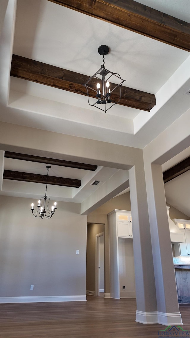 interior space featuring a chandelier, beam ceiling, and visible vents