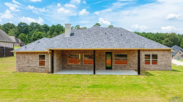 back of property featuring a patio area and a yard