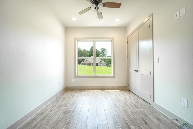 unfurnished room featuring ceiling fan and light hardwood / wood-style floors