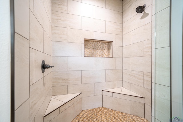 bathroom with tiled shower