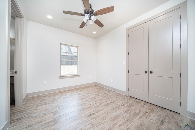 unfurnished bedroom featuring ceiling fan, a closet, and light hardwood / wood-style flooring