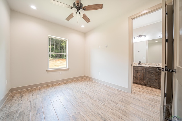 empty room featuring ceiling fan and sink