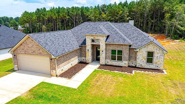 view of front of house with a front yard and a garage