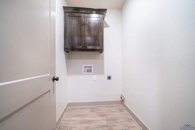 laundry area featuring hookup for an electric dryer, washer hookup, and cabinets