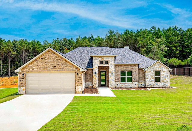 view of front of home with a garage and a front lawn