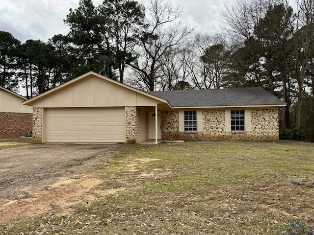 single story home with a front lawn, an attached garage, and driveway