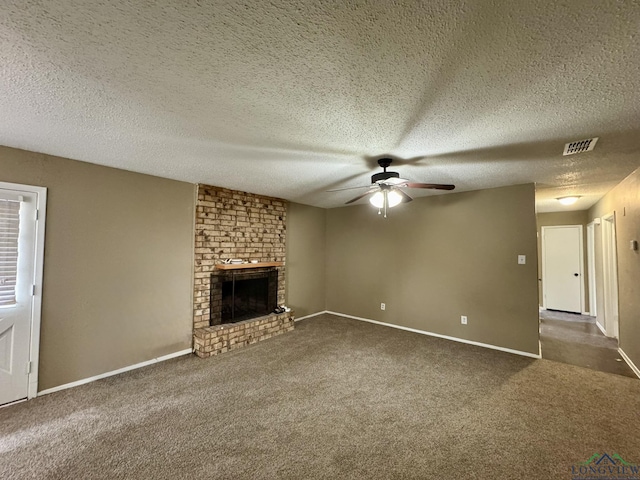 unfurnished living room with carpet, baseboards, visible vents, a ceiling fan, and a fireplace