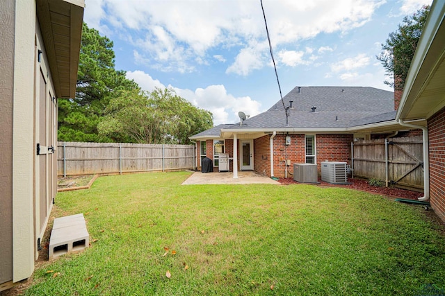 view of yard featuring central AC unit and a patio