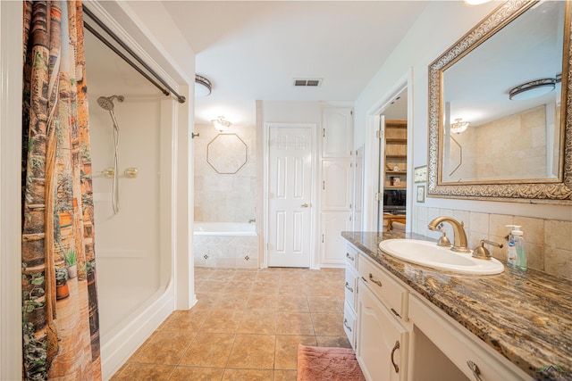 bathroom with decorative backsplash, shower with separate bathtub, vanity, and tile patterned flooring