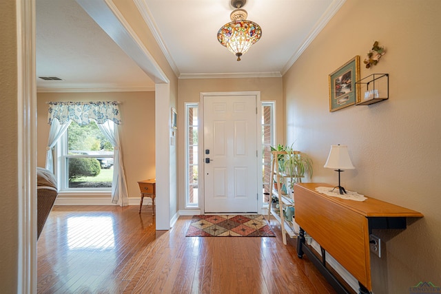 entrance foyer featuring hardwood / wood-style floors and crown molding