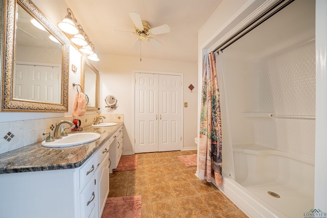 bathroom with vanity, ceiling fan, backsplash, and a shower with shower curtain