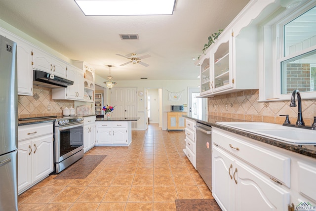 kitchen featuring white cabinets, appliances with stainless steel finishes, sink, and tasteful backsplash