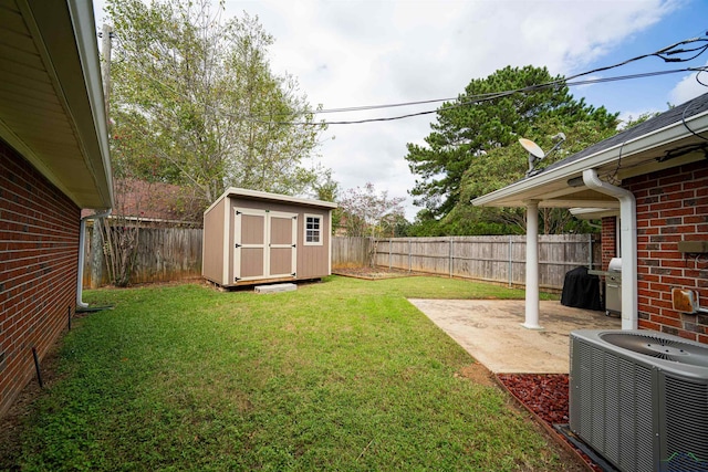 view of yard with central air condition unit, a storage unit, and a patio