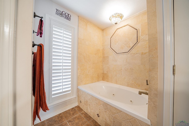 bathroom with a relaxing tiled tub and tile patterned floors