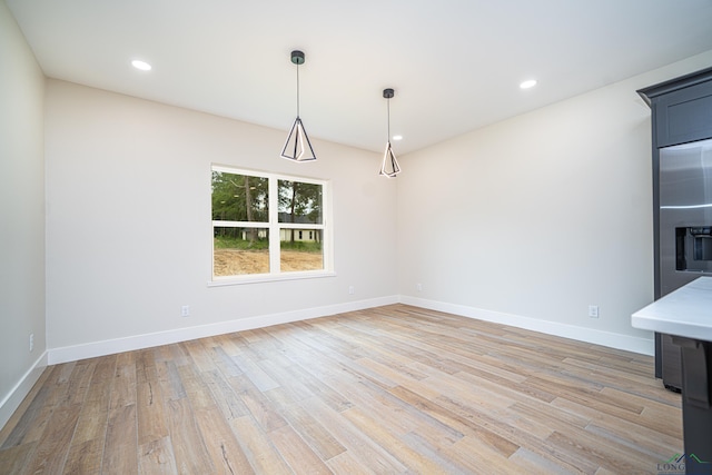 unfurnished dining area with light wood-type flooring