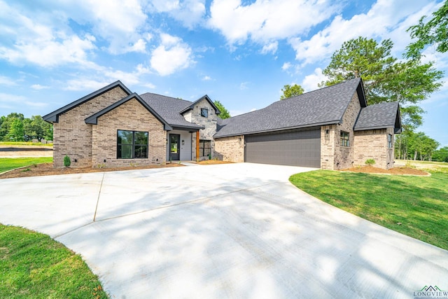 view of front facade with a garage and a front lawn