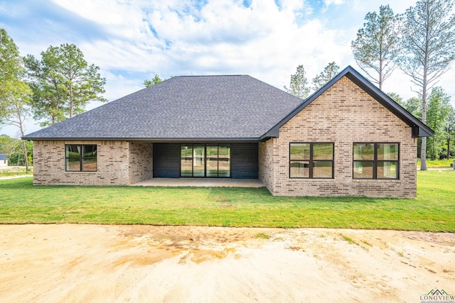 back of house with a patio area and a yard