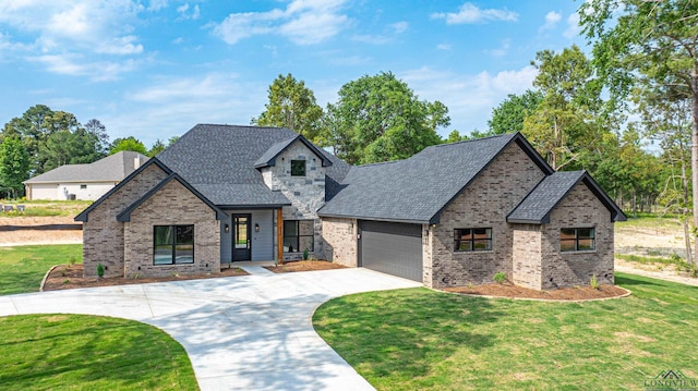 view of front of home with a garage and a front yard