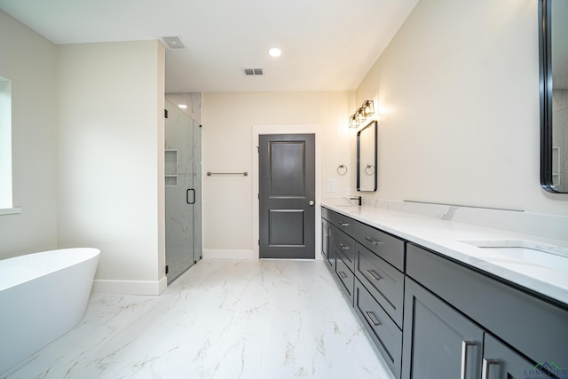 bathroom with vanity and shower with separate bathtub