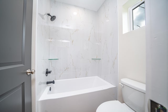 bathroom featuring toilet and tiled shower / bath