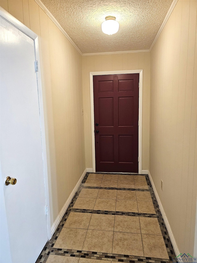 entryway with tile patterned floors, a textured ceiling, and wooden walls