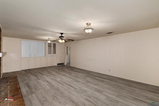 unfurnished living room with hardwood / wood-style floors and ceiling fan