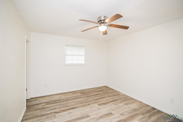 unfurnished room with light wood-style floors, baseboards, ceiling fan, and a textured ceiling