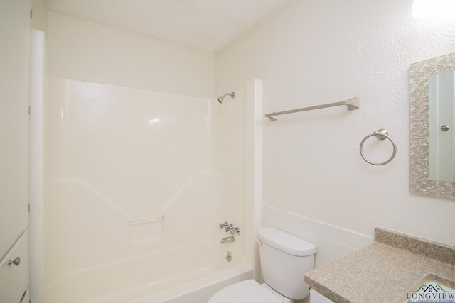 bathroom with shower / bathtub combination, toilet, and vanity