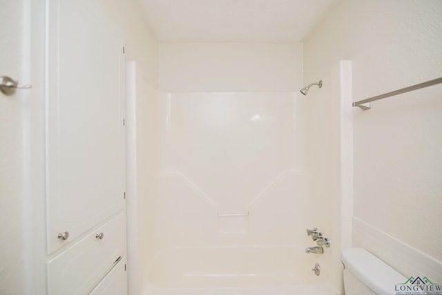 bathroom featuring bathtub / shower combination and toilet