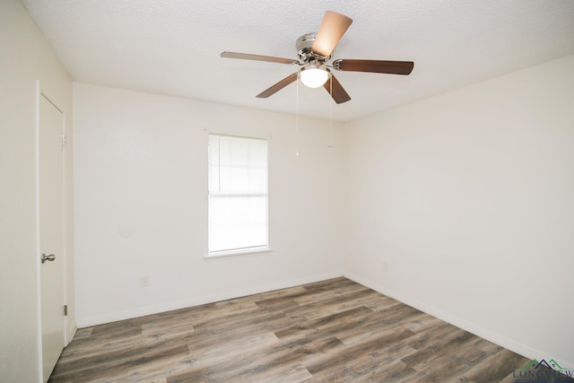 unfurnished room featuring baseboards, ceiling fan, and wood finished floors