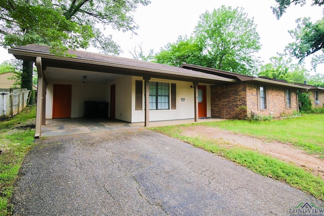 single story home with fence and driveway