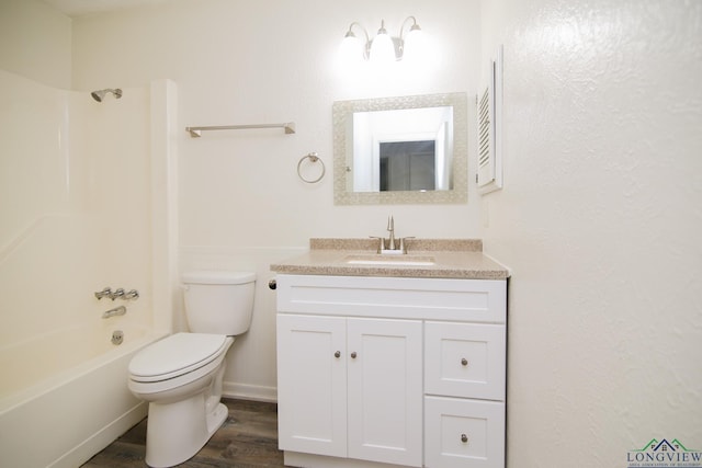 full bathroom with wood finished floors, baseboards, vanity, toilet, and shower / bathtub combination