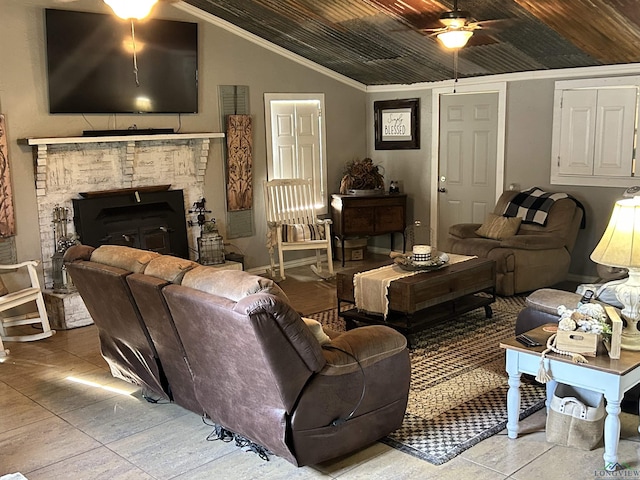 living room featuring a wood stove, ceiling fan, wood ceiling, and vaulted ceiling