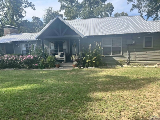 back of property featuring a yard