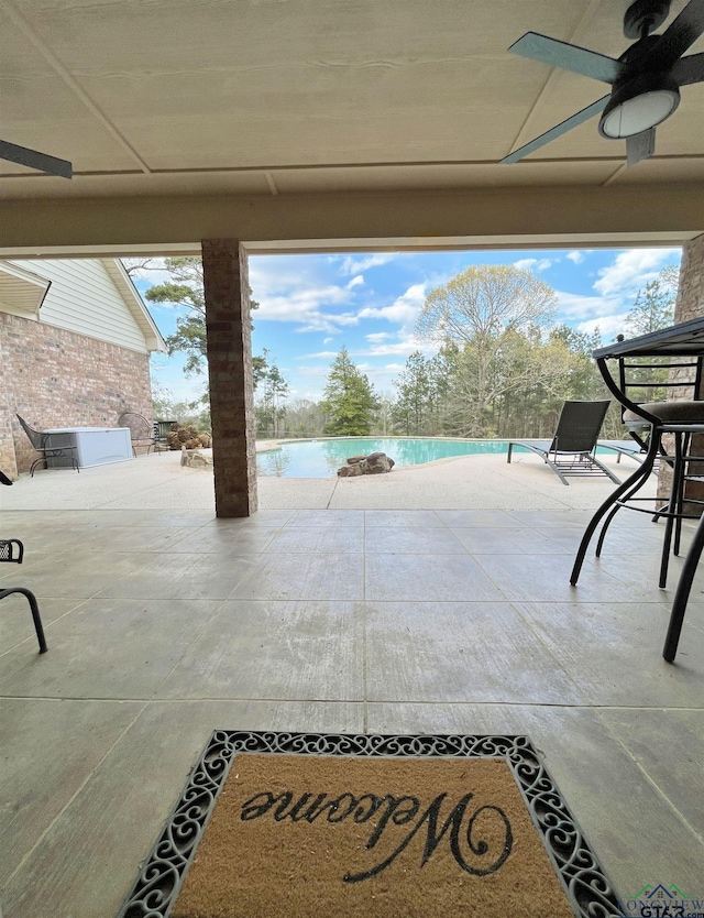 view of patio featuring ceiling fan and a water view