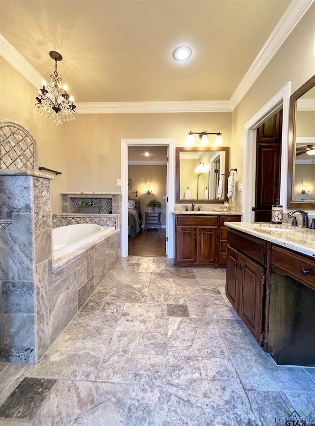 bathroom featuring vanity, crown molding, a notable chandelier, and tiled tub