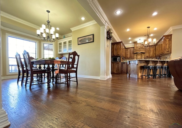 dining area with a chandelier, dark wood-type flooring, and ornamental molding