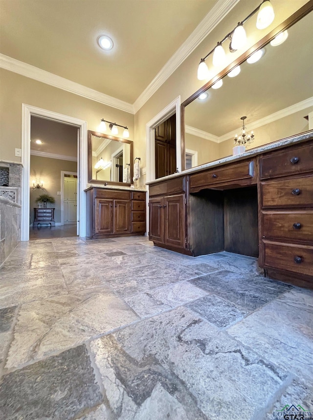 bathroom with vanity, an inviting chandelier, and ornamental molding