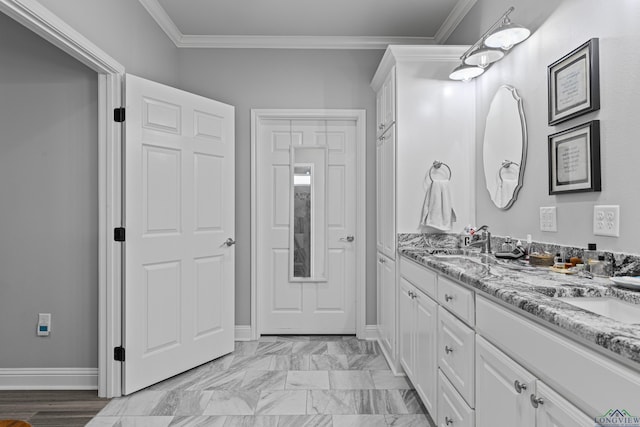 bathroom featuring crown molding and vanity